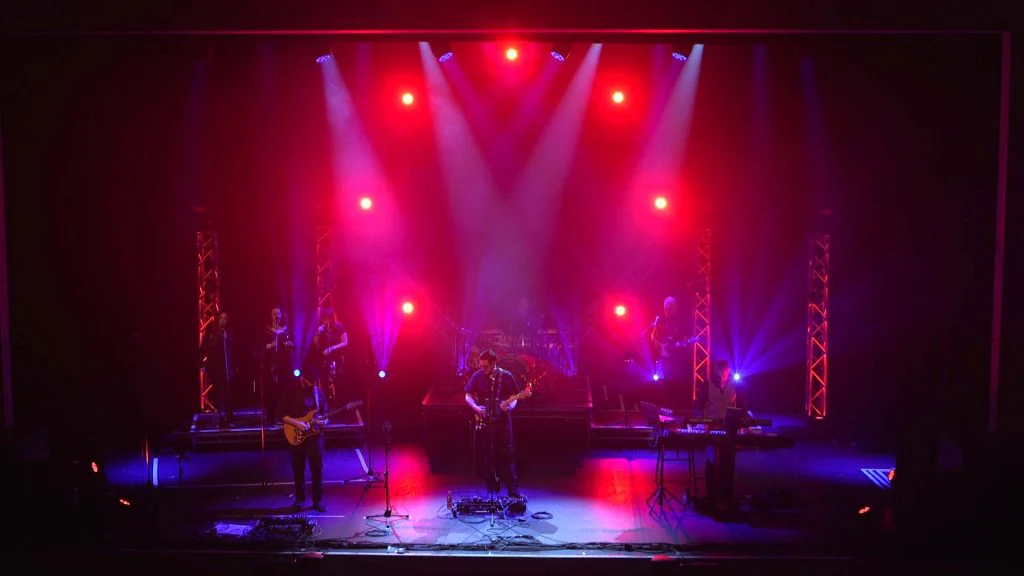 Beams of stage light visible through atmospheric haze