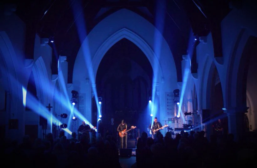 Band performing with lighting and sound in a church venue